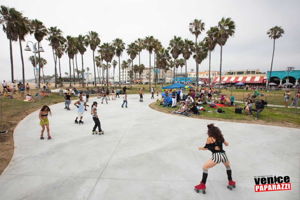 People roller skating on a cement path