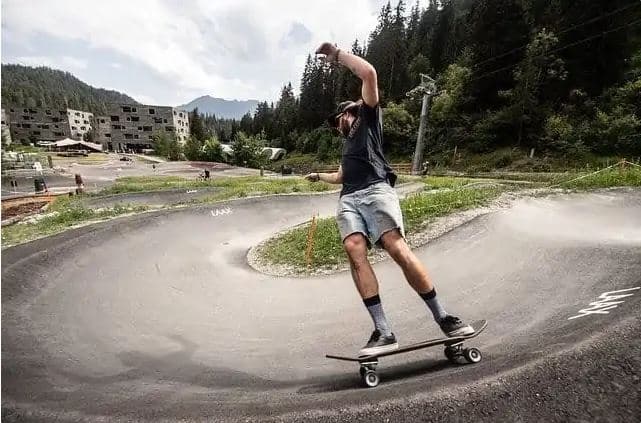 Skateboarder banking a turn on the longboard trail