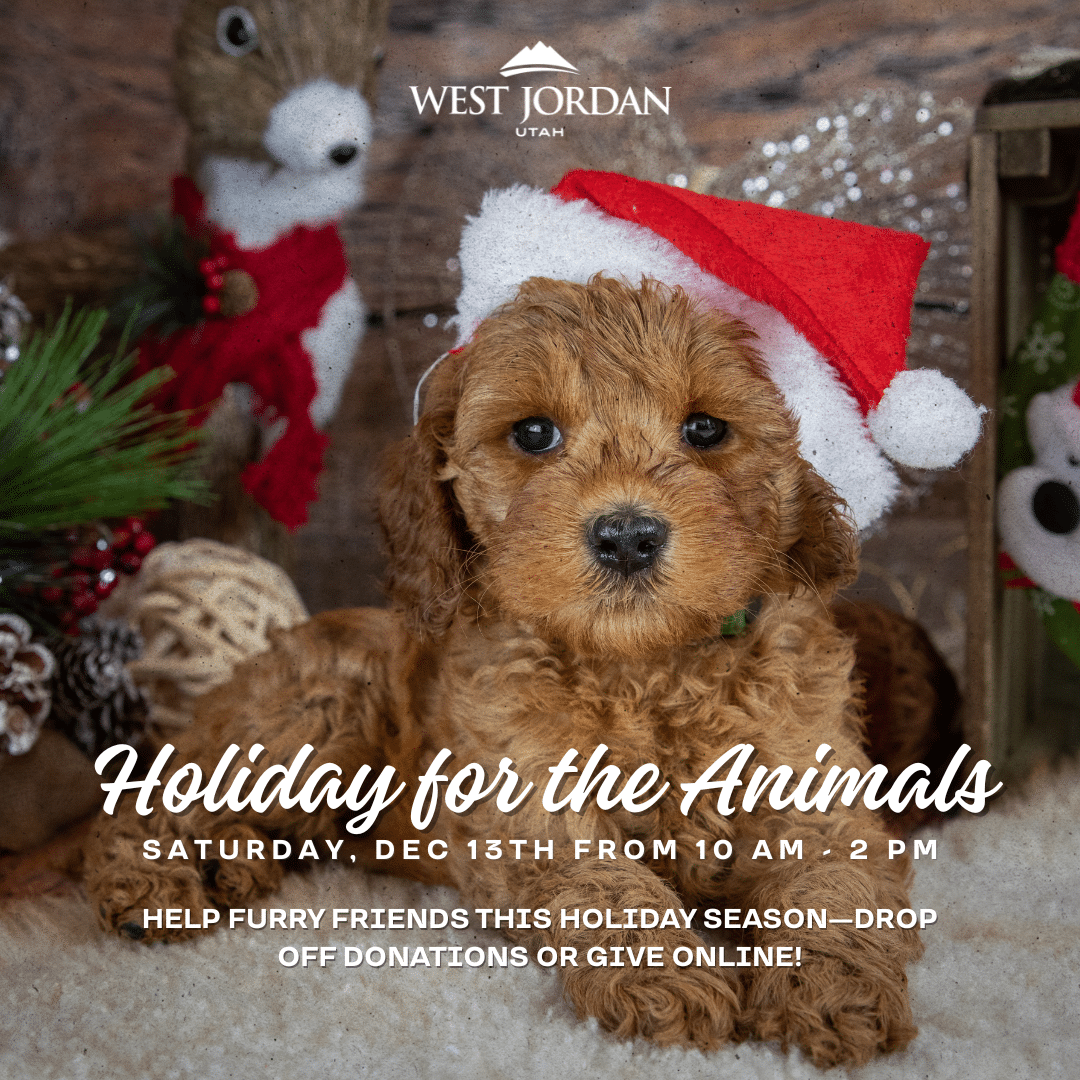 A brown puppy wearing a red Santa hat sits in front of festive holiday decorations. Text promotes “Holiday for the Animals” event in West Jordan on Saturday, Dec 13th, encouraging donations for animals.