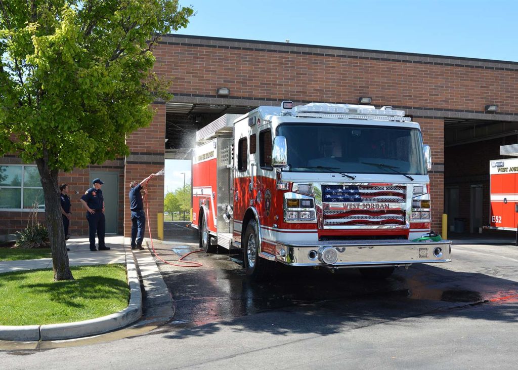 Fire fighters washing down new fire engine